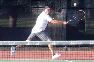  ?? NEWS PHOTOS RYAN MCCRACKEN ?? (Above) Peter O'Driscoll serves to Ryan Comeau during a men's open match in the Medicine Hat Tennis Club Open on Wednesday. (Left) John Davies returns a shot to Kerry McDowell during a men’s open match.