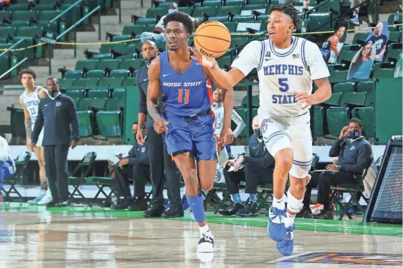  ?? PHOTOS BY NICK GRAVOIS/NORTH TEXAS ATHLETICS ?? Boise State's Devonaire pursues Memphis' Boogie Ellis in the quarterfinal round of the NIT.