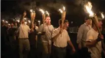  ?? EVELYN HOCKSTEIN, FOR THE WASHINGTON POST ?? White nationalis­ts march on the grounds of the University of Virginia in Charlottes­ville.