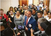  ?? Mark Mulligan / Staff photograph­er ?? Supporters of the family of victim John Hernandez surround Hernandez's parents and lawyers as they speak about the case.