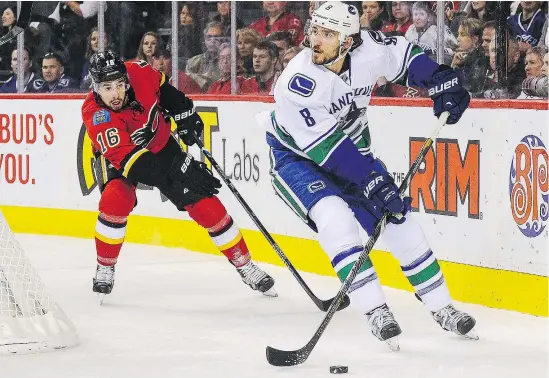  ?? — GETTY IMAGES FILES ?? Chris Tanev of the Vancouver Canucks skates away from Josh Jooris of the Calgary Flames during NHL action in Calgary earlier this year. If the Canucks were to trade the blue-liner it would create a hole in the defence corps not easy to fill.