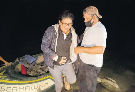  ?? AP ?? In this March 30, 2021, file photo Mayra Culio from Guatemala is helped off an inflatable raft by a church volunteer after being smuggled across the Rio Grande river in Roma, Texas. Assailants shot her 7 times at her house and then killed her husband who was ambushed in his car in Escuintla, Guatemala. She is five months pregnant and fled with her extended family March 12 after being treated in the hospital for her bullet wounds. The Biden administra­tion will stop detaining migrants facing deportatio­n if they are pregnant or recently gave birth in a reversal of a Trump-era policy.