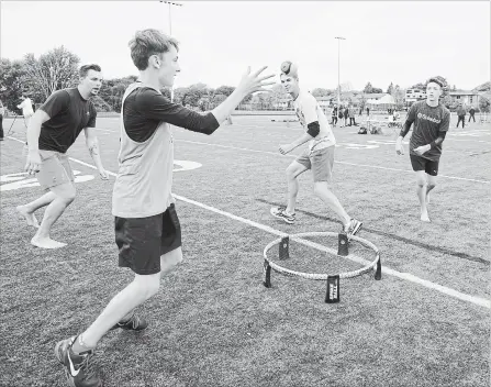  ?? PETER LEE WATERLOO REGION RECORD ?? Ryan Wilson (left), Robert Fardy, Patrick Fernie, and Jared Dewar play Spikeball at the Fitness Feeds the Community event at St. David Catholic Secondary School, Waterloo, on Sunday.