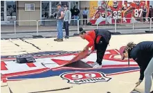  ?? [BERRY TRAMEL/ THE OKLAHOMAN] ?? Workers tear down the court at the Big 12 Tournament Fan Fest outside Kansas City's Sprint Center last March. The event was canceled amid COVID concerns.