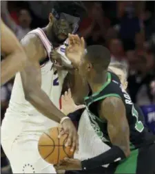  ?? MATT SLOCUM — THE ASSOCIATED PRESS ?? Joel Embiid, left, and the 76ers put up a fight against Terry Rozier and the Celtics to stave off eliminatio­n, 103-92, in Game 4 Monday.