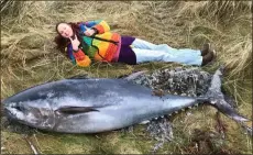  ??  ?? „ Sanday Ranger Emma Neave-webb next to the giant Atlantic bluefin tuna.