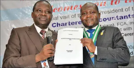  ??  ?? L-R: The President, Institute of Chartered Accountant­s of Nigeria (ICAN), Alhaji Ismaila Zakari and the Vice-Chancellor of Caleb University, Professor Ayandeji Aina displaying the MoU signed between ICAN and the university, in Lagos... recently