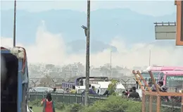  ??  ?? The cloud of dust in the mountains where the earthquake had demolished villages in Nepal.