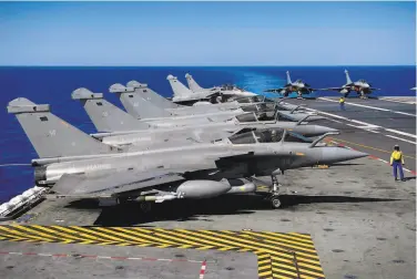  ?? Eric Feferberg / AFP via Getty Images 2016 ?? Egypt has agreed to buy 30 more French Rafale fighter jets, seen here on a French aircraft carrier in 2016. Egypt has now built up its fleet of the advanced warplane to 54, second only to the French air force.