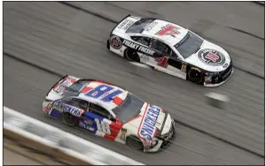  ?? AP/PAUL ABELL ?? Drivers Kyle Busch (18) and Kevin Harvick (4) race down the front stretch during the NASCAR Monster Energy Cup Series race Sunday at Atlanta Motor Speedway in Hampton, Ga. Harvick won the race and Busch finished seventh.