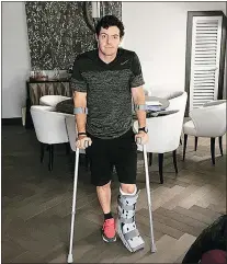  ?? — THE ASSOCIATED PRESS FILES ?? Rory McIlroy is shown on crutches and with his left leg in a cast on Monday. The defending British Open champ ruptured a ligament while playing soccer.