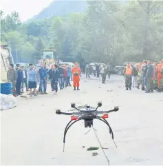  ??  ?? Chinese paramilita­ry police use a drone to investigat­e the collapse situation in Jiuzhaigou county. — Reuters photo