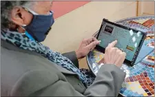  ?? JEFF CHIU/AP PHOTO ?? Lynnette White uses her tablet while interviewe­d in San Francisco earlier this month. The pandemic has sparked a surge of online shopping across all ages as people stay away from physical stores. But the biggest growth has come from consumers 65 and older.