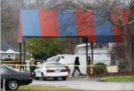  ?? JOHN MINCHILLO — THE ASSOCIATED PRESS ?? Members of the ATF and local police work at a crime scene at Cameo club after a fatal shooting, Sunday in Cincinnati. the