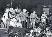  ??  ?? Doing it their way: (from left) Gina Schock, Belinda Carlisle, documentar­ist Alison Ellwood, Jane Wiedlin, Charlotte Caffey and Kathy Valentine. Above, the Go-Go’s performing at the Whisky a Go Go