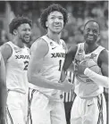  ?? CHRIS CARLSON/AP ?? Xavier guard Desmond Claude (1) and guard Souley Boum, right, celebrate after their win against Pittsburgh on Sunday in Greensboro, N.C.