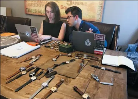  ?? AP PHOTO/AMIR BIBAWY ?? Watches lie on a table in front of Christian Zeron as he talks with Anna Griffin in Westfield, N.J. Zeron’s company website, theoandhar­ris. com, sells $2 million worth of watches annually. Regularly Zeron gets hundreds of thousands of views for his four weekly video posts on YouTube.