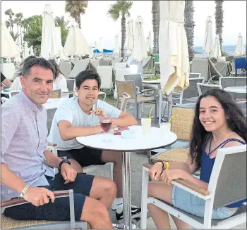  ??  ?? MERRY BAND: Michael with his children James and Molly and all-inclusive wrist IDs