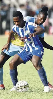  ??  ?? Waterhouse’s Ricardo Thomas stays close to Mount Pleasant’s Cardel Benbow (foreground) during their Red Stripe Premier League encounter at Drax Hall yesterday. Mount Pleasant won 1-0.