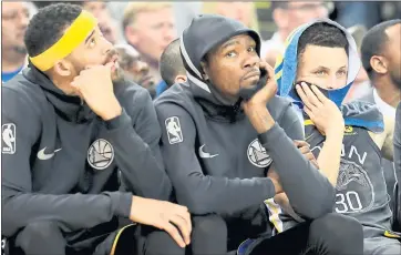  ?? FILE PHOTO ?? From left, Golden State Warriors’ JaVale McGee, Kevin Durant and Stephen Curry show their frustratio­n as they sit on the bench during the final minutes of a loss to the Oklahoma City Thunder at Oracle Arena in Oakland in February.