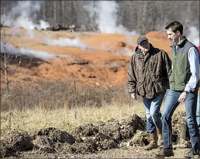  ?? NWA Democrat-Gazette/BEN GOFF ?? Kevin White (left), associate director of land resources with the Arkansas Department of Environmen­tal Quality, leads Arkansas’ U.S. Sen. Tom Cotton and others on a tour Friday at the stump dump fire site in Bella Vista.