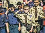  ?? JAKE MAY/THE FLINT JOURNAL — MLIVE.COM VIA AP ?? Boy Scouts and Cub Scouts salute during a Memorial Day ceremony in Linden, Mich., in May.