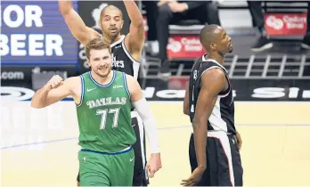  ?? KYUSUNG GONG/AP ?? Mavericks guard Luka Doncic, bottom left, reacts after drawing a foul during the first half of a game against the Clippers on Sunday in Los Angeles.
