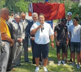  ?? STAN HUDY - SHUDY@DIGITALFIR­STMEDIA.COM ?? Troy High School football coach Bob Burns addresses the media prior to the unveiling of a new sign commemorat­ing the Flying Horses back-to-back state titles.