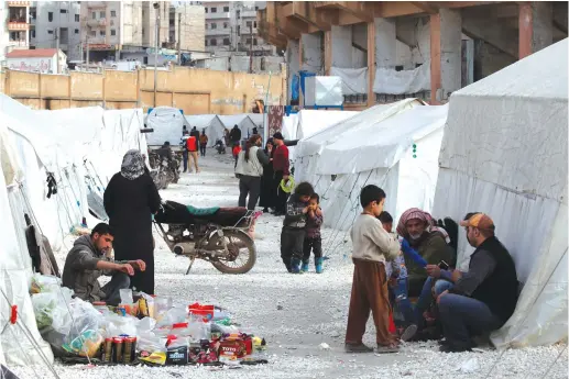  ?? (Umit Bektas/Reuters) ?? INTERNALLY DISPLACED Syrians are seen in an IDP camp in a sports stadium in Idlib, last week.