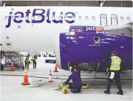  ?? AFPPIC ?? Employees of Jet Blue airline working on an engine of an Airbus A320 passenger aircraft in a maintenanc­e hangar of the company at JFK Internatio­nal Airport in New York. –