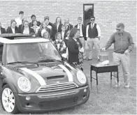  ?? Staff photo by Jennifer Middleton ?? ■ Students at Veritas Academy watch Monday as the school’s accountant, Troy Lemons, draws a name in a raffle to win a 2006 Mini Cooper. The school bought the car to raise money for students needing tuition assistance. It’s the second year for the...