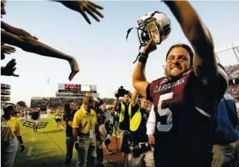  ?? AP PHOTO/MARY ANN CHASTAIN ?? South Carolina quarterbac­k Stephen Garcia celebrates as he leaves the field after the Gamecocks beat topranked Alabama 35-21 on Oct. 9, 2010, at Williams Brice Stadium in Columbia, S.C.