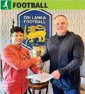  ?? ?? FSL President Jaswar Umar shakes hands with national coach Andy Morrison after his contract was extended for two years