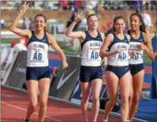  ?? PETE BANNAN — DIGITAL FIRST MEDIA ?? Villanova’s McKenna Keegan, Siofra Cleirigh Buttner, Nicole Hutchinson and Angel Piccirillo (left to right) take a victory lap after winning the DMR last year at the Penn Relays. All but Piccirillo return. Cleirigh Buttner has six relay championsh­ips...