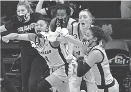  ?? DAVID ZALUBOWSKI/AP ?? From left, Colorado guard Lesila Finau and forwards Charlotte Whittaker and Tayanna Jones react after beating Stanford on Sunday.