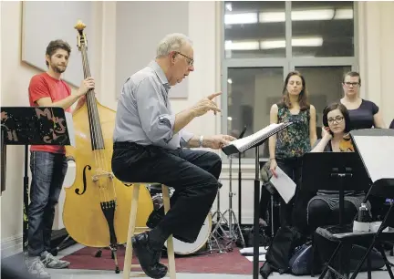  ?? MA R I E - F R A NC E C O A L L I E R / MO N T R E A L G A Z E T T E ?? Iwan Edwards, centre, gestures as he rehearses with a class at McGill University’s Schulich School of Music on Wednesday. The former OSM chorus master and pillar of the English musical community is retiring.