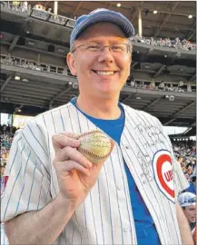  ?? | SCOTT STEWART~SUN-TIMES ?? Grant DePorter at Wrigley Field on Tuesday with the ball that was in play during the last out in the 1945 World Series, which the Cubs lost.