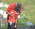  ?? MIKE EHRMANN/GETTY IMAGES ?? Tiger Woods and son Charlie Woods hug during the final round of the PNC Championsh­ip on Sunday.