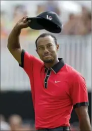  ?? MARK DUNCAN — THE ASSOCIATED PRESS FILE ?? In this file photo, Tiger Woods waves on the 18th green after winning the Bridgeston­e Invitation­al golf tournament at Firestone Country Club in Akron, Ohio.. That was Woods’ last victory. He returns to the PGA Tour this week with young players...