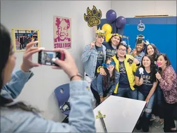  ?? Photograph­s by Allen J. Schaben Los Angeles Times ?? TEACHER Mercelena Vasquez-Funk, right, poses with Warren High students at an IDEAS meeting Wednesday. She started the club, which stands for “improving dreams, equality, access and success,” in 2012.