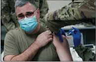  ?? (AP/Rogelio V. Solis) ?? Brig. Gen. Clint Walker of the Mississipp­i National Guard gets the first round of the Moderna vaccine Wednesday in Flowood, Miss. Officials have administer­ed 200 doses to Guard members who serve as first responders or work at coronaviru­s testing sites.