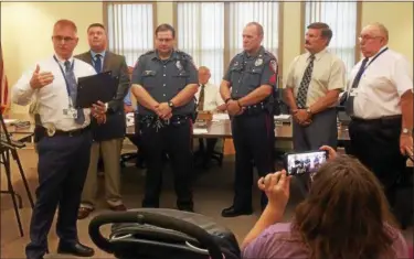  ?? EVAN BRANDT — DIGITAL FIRST MEDIA ?? At left, Lowers Pottsgrove Police Chief Michael Foltz explains the circumstan­ces of a June 3 strong-arm robbery at the Turkey Hill convenienc­e store solved by, from left, Detective Daniel Kienle, Officer Matt Musselman and Sgt. Robert Greenwood. Next to them are township commission­ers Earl Swavely Jr. and Ray Lopez.