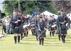  ??  ?? Achievers: pupils reach the top of Mount Kilimanjar­o, and playing their part in Strathmore Highland Games.