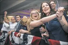  ?? Stephanie Strasburg/Post-Gazette ?? Campaign volunteers Erin Weaver, front left, of Green Tree and Morgan Kelly of Dormont celebrate at Conor Lamb’s election night party.