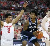  ?? JAY LAPRETE — THE ASSOCIATED PRESS ?? Villanova’s Saddiq Bey looks for an open shot against Ohio State’s D.J. Carton Wednesday. The Wildcats dropped a 76-51 decision to the 18th-ranked Buckeyes.