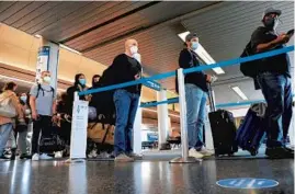  ?? ANTONIO PEREZ/CHICAGO TRIBUNE ?? Air travelers line up March 11 to board an American Airlines flight to Jackson Hole, Wyoming, departing from O’Hare Internatio­nal Airport. Airlines are indicating that prices are on the rise as demand for flying picks up heading into the summer.