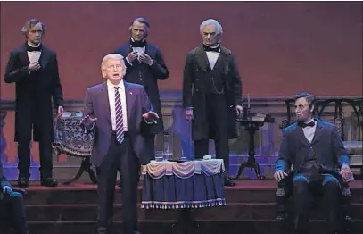  ?? [DISNEY WORLD] ?? An animatroni­c version of President Donald Trump joined the Hall of Presidents for its reopening Tuesday at Walt Disney World in Orlando, Fla. The robotic facsimile moves his head during the traditiona­l roll call of the nation’s 45 leaders, motions...