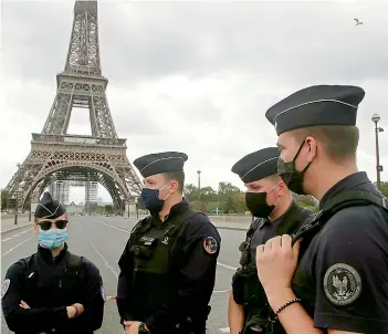  ?? —AP ?? French police officers secure the bridge leading to the Eiffel Tower, Wednesday, Sept. 23, 2020 in Paris. Paris police have blockaded the area around the Eiffel Tower after a phone-in bomb threat.