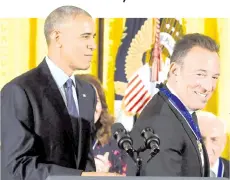  ?? — AFP file photo ?? Obama looks on after presenting musician Bruce Springstee­n with the Presidenti­al Medal of Freedom, the nation’s highest civilian honor, during a ceremony honoring 21 recipients, in the East Room of the White House in Washington, DC.