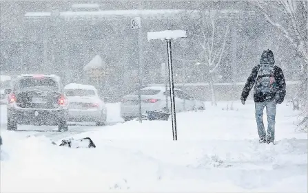  ?? MIKE DIBATTISTA SPECIAL TO THE NIAGARA FALLS REVIEW ?? A blast of winter weather Wednesday morning filled sidewalks and roads making travel difficult for pedestrian­s and motorists around Niagara Falls.